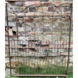 An old wrought iron pedestrian gate with hooped detail, 102cm wide x 122cm high (af)