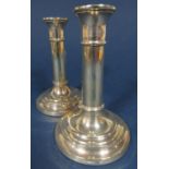 Contemporary pair of silver canon candlesticks upon stepped circular bases, 15 cm high