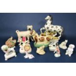 A collection of 19th century and later model animals including a Staffordshire figure of a black and