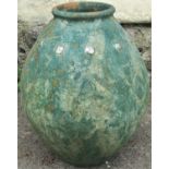 A pot bellied terracotta urn/jar with repeating relief moulded buttoned collar and weathered green