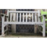 A weathered Gloucester teak two seat garden bench with slatted seat and back, 4ft long approx