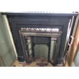 A reclaimed cast iron fire surround/chimney piece with fluted frieze, the mantle 130 cm wide,