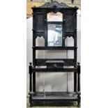 A Victorian Gothic dark oak hall stand of full height, with carved framework, enclosing a