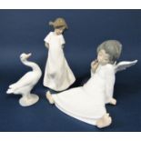 A Lladro Daisa figure of a seated angel, together with a Lladro figure of a goose and a Nao figure