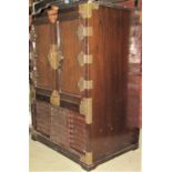 Two Korean chests of similar form, one enclosed by a pair of panelled doors with open section below,