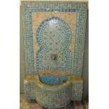 A reclaimed Moroccan mosaic water feature/fountain with bow fronted reservoir and raised back with
