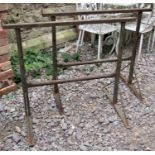 A pair of weathered iron work builders trestles with adjustable height