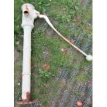 A reclaimed and weathered cream painted heavy cast iron lever hand operated water pump, with foliate