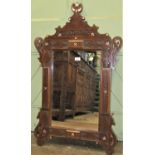 A Moroccan mirror, the carved hardwood frame with repeating geometric detail, with additional mother
