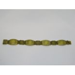 Unusual yellow metal bracelet with alternating embossed panels and gate links with Greek key