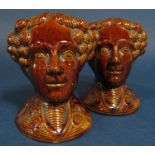 A pair of early 19th century treacle glazed sash window supports modelled as female heads, 12cm tall