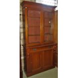 A Victorian mahogany library bookcase enclosed by two panelled doors and frieze drawer, the upper