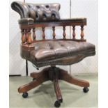 A reproduction Victorian style office chair with horseshoe shaped back and turned spindle mouldings,