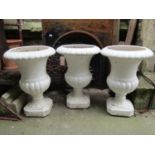 A set of three moulded plastic campana shaped garden urns, 46cm diameter x 66cm high approx