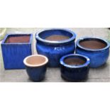Five small reclaimed blue glazed planters, four circular and one square, the largest 30cm diameter x