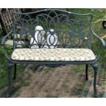 A contemporary green painted cast aluminium two seat garden bench with decorative pierced