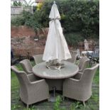 A suite of Bramblecrest faux wicker garden furniture comprising oval table, with central parasol