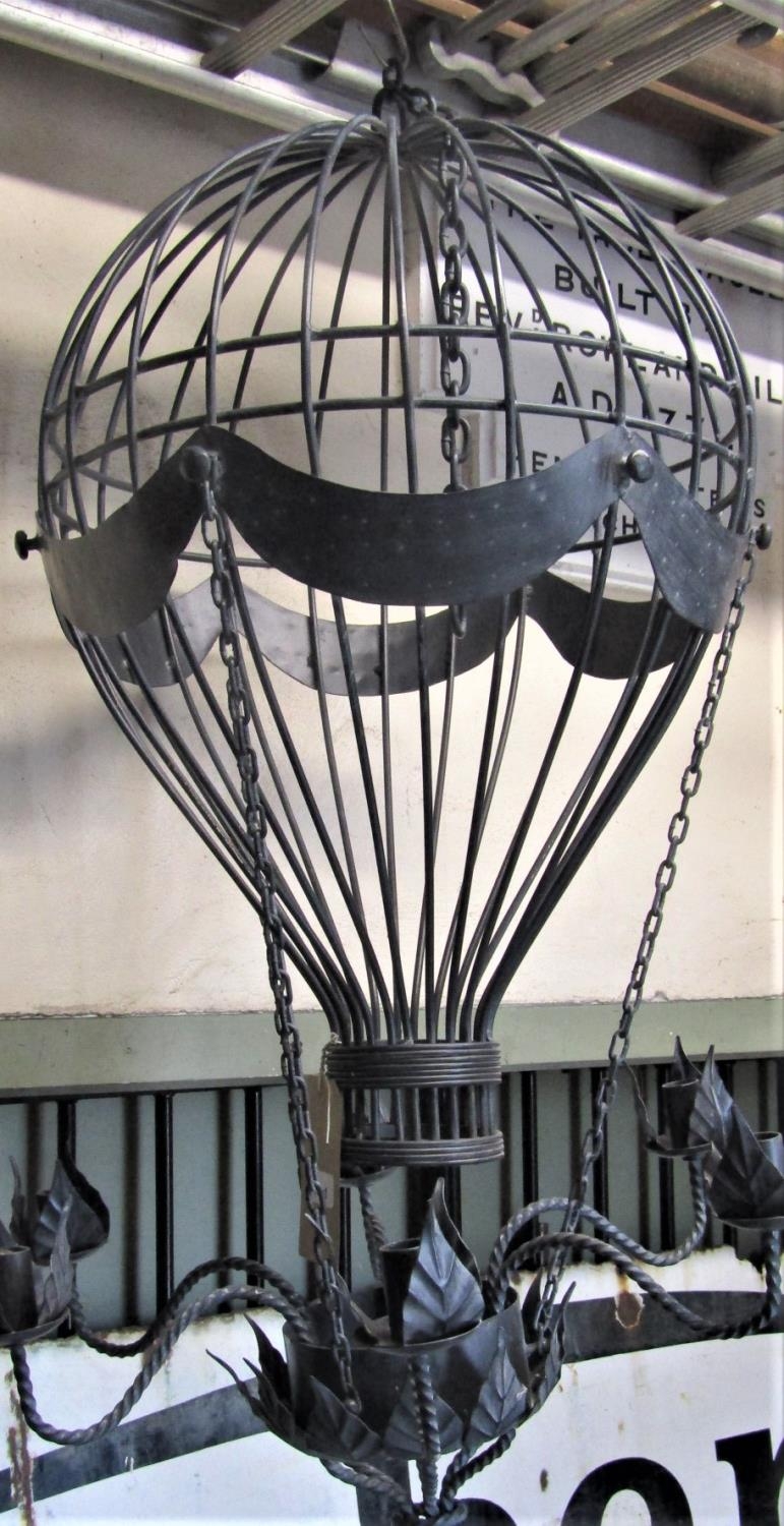 A novel contemporary cast metal hanging ceiling light in the form of a balloon with six rope twist