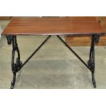 A Victorian mahogany top table raised on a pair of shaped and pierced iron supports, 107cm x 59cm