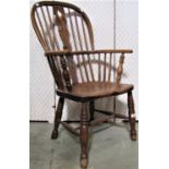 A Georgian Windsor comb back elbow chair principally in elm and ashwood with pierced splats on