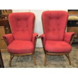 An Ercol stick back three piece suite comprising a two seat sofa and two matching high back chairs