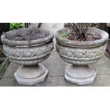 A pair of reclaimed garden planters with circular lobed and foliate banded bowls, raised on socles