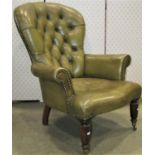 A Victorian style drawing room chair upholstered in green leather with buttoned back on turned