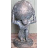 A reclaimed garden ornament in the form of Atlas kneeling/crouching carrying the world with