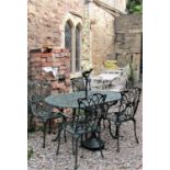 A contemporary green painted cast aluminium garden terrace table of oval form with decorative