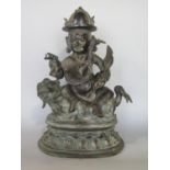 Good antique Eastern brass study of two Buddhistic deities upon a dog of fo, the gentleman character