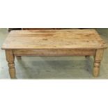 A low stripped pine occasional table of rectangular form with rounded corners and turned supports,