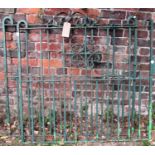 A pair of heavy gauge ironwork entrance gates, with vertical rails and C scroll panels, 236cm