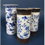 A 19th century oriental vase of cylindrical form with blue and white painted bird and floral