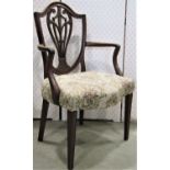A set of four Georgian shield back mahogany elbow chairs with carved an pierced splats and