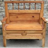 A 19th century stripped and waxed pine settle, with box seat and rising cover, the back with