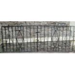 Two pairs of ironwork driveway entrance gates and matching pedestrian gates, varying design but both