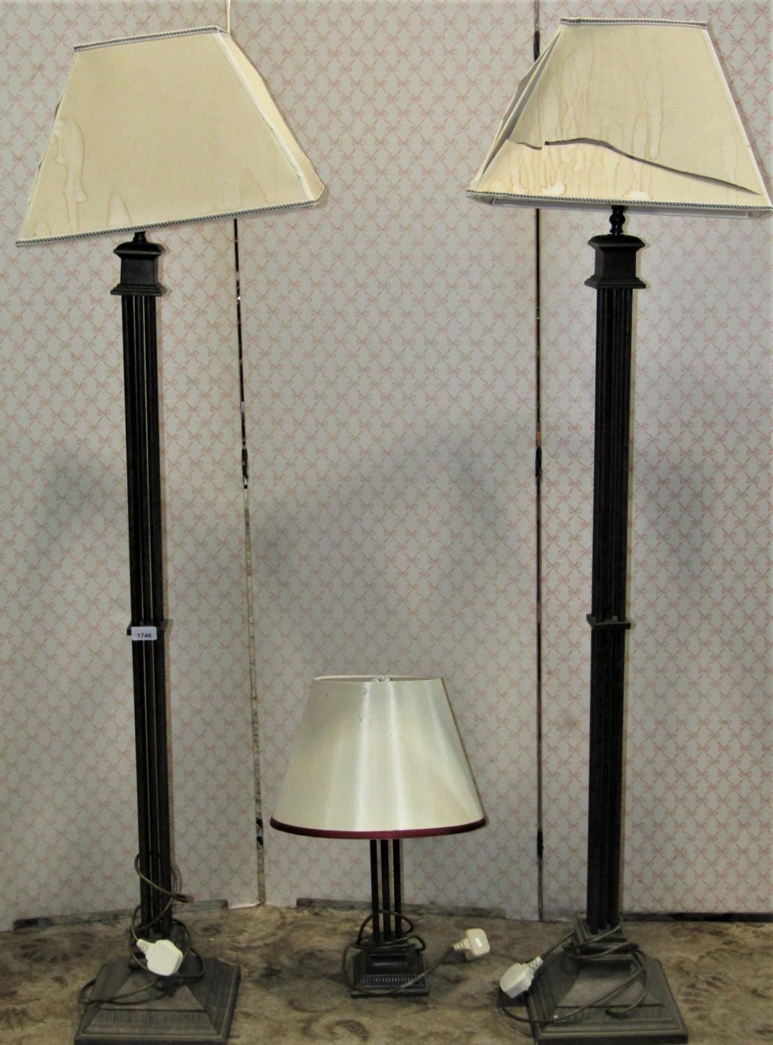 A pair of contemporary ironwork lamp standards with column supports, together with a matching