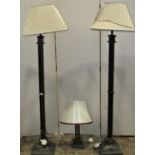 A pair of contemporary ironwork lamp standards with column supports, together with a matching