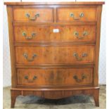 A Georgian style yew wood veneer chest of three long and two short drawers, the chest with shallow