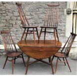 An Ercol dropleaf dining table on square cut supports together with a set of four Ercol stick back