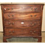 A small 19th century mahogany chest of four long graduated drawers, with canted corners raised on