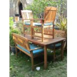 A contemporary five piece hardwood garden suite comprising table of rectangular form with slatted