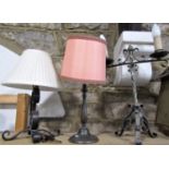 An unusual wrought iron twin branch table lamp, with wrythen fluted stem, 46cm high, together with a