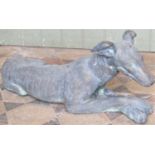 A reclaimed simulated bronze ornament in the form of a recumbent whippet, 62 cm long x 26 cm high