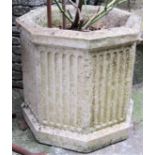 A reclaimed octagonal fluted planter containing a rose, together with a pair of further reclaimed