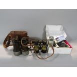 Two pairs of vintage binoculars to include a cased leather clad pair, together with a further