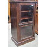 A Victorian rosewood side cabinet enclosed by a glazed panelled door with shelf lined interior,