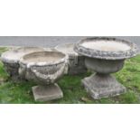 Four reclaimed garden urns, of varying design to include a pair of circular form with repeating ring