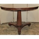 A 19th century mahogany tea table, the circular top 102 cm in diameter, raised on a tapering