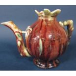 An oriental Cadogan teapot with streaked and mottled ox-blood style glazed finish, modelled as a